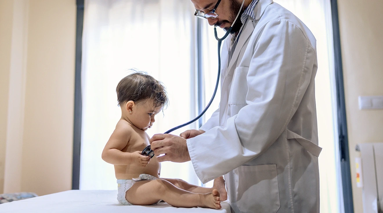 doctor examining 1 year old baby