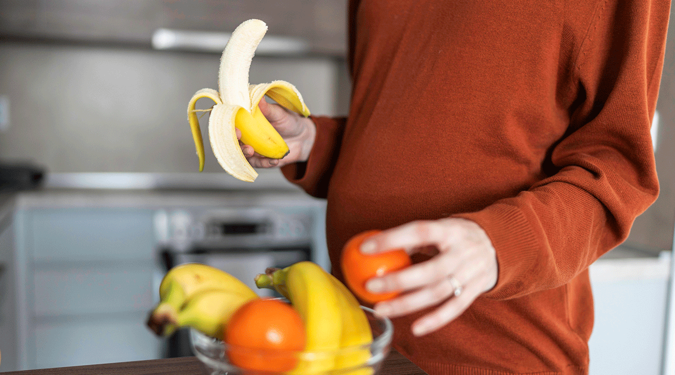 pregnant woman eating a banana