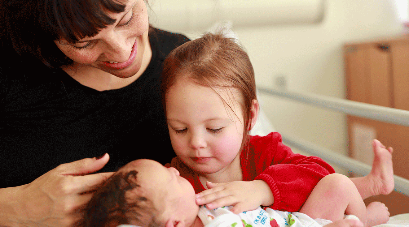 sibling meeting new baby in hospital