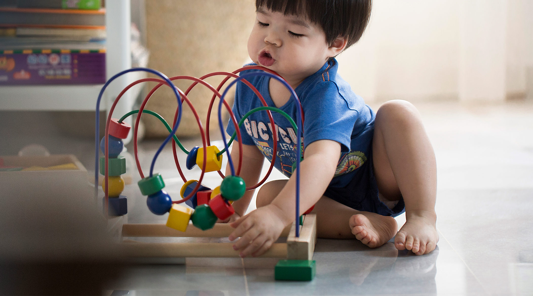 toddler playing with toy at daycare