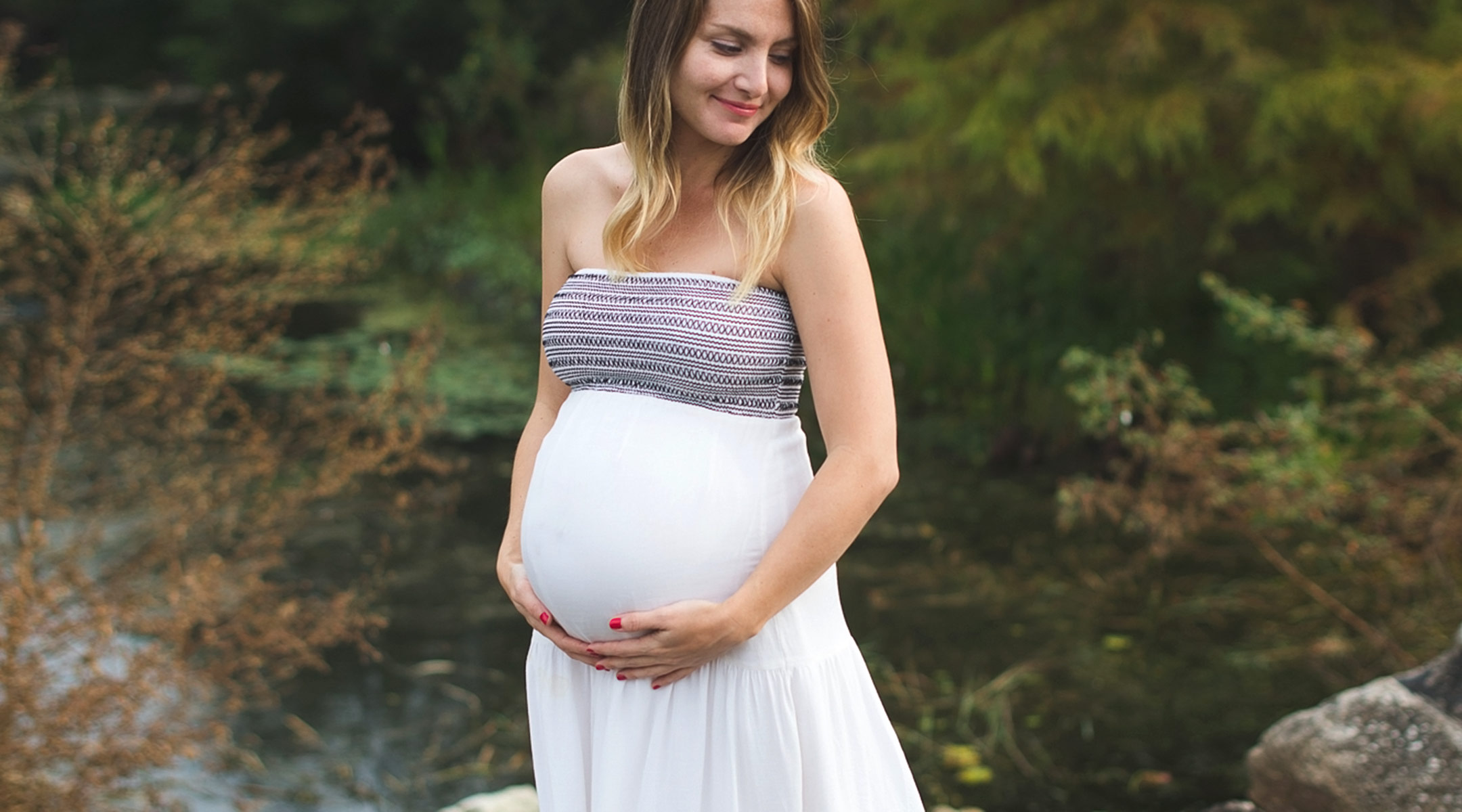 pregnant woman outside in natural setting