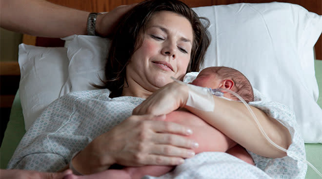 Mom and newborn baby in the hospital after giving birth via c-section. 