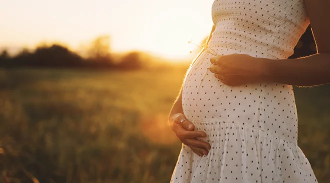 close up of pregnant woman during sunset