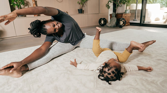 African-American mother and baby practicing yoga as a form of self-care for moms