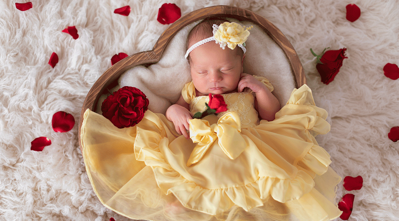 newborn baby dressed in disney princess dress