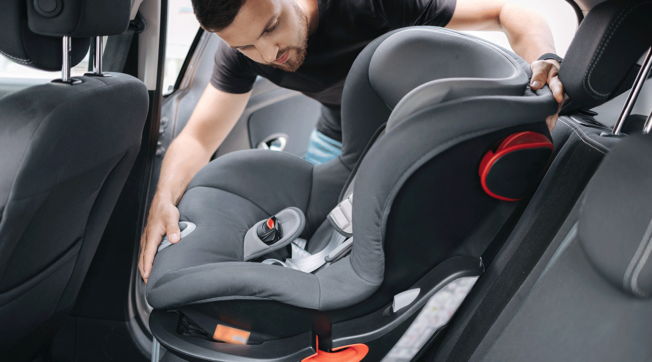 father removing car seat from car