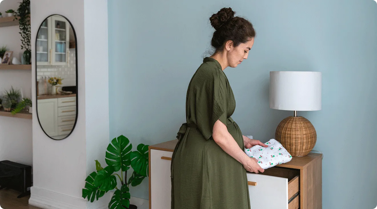 pregnant woman at home organizing and preparing for baby
