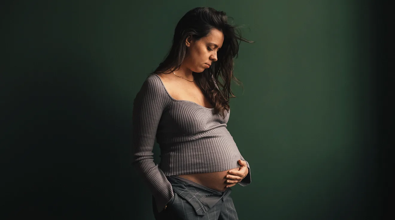 pregnant woman standing by the window