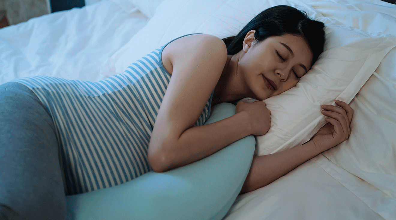 pregnant woman sleeping in bed at night