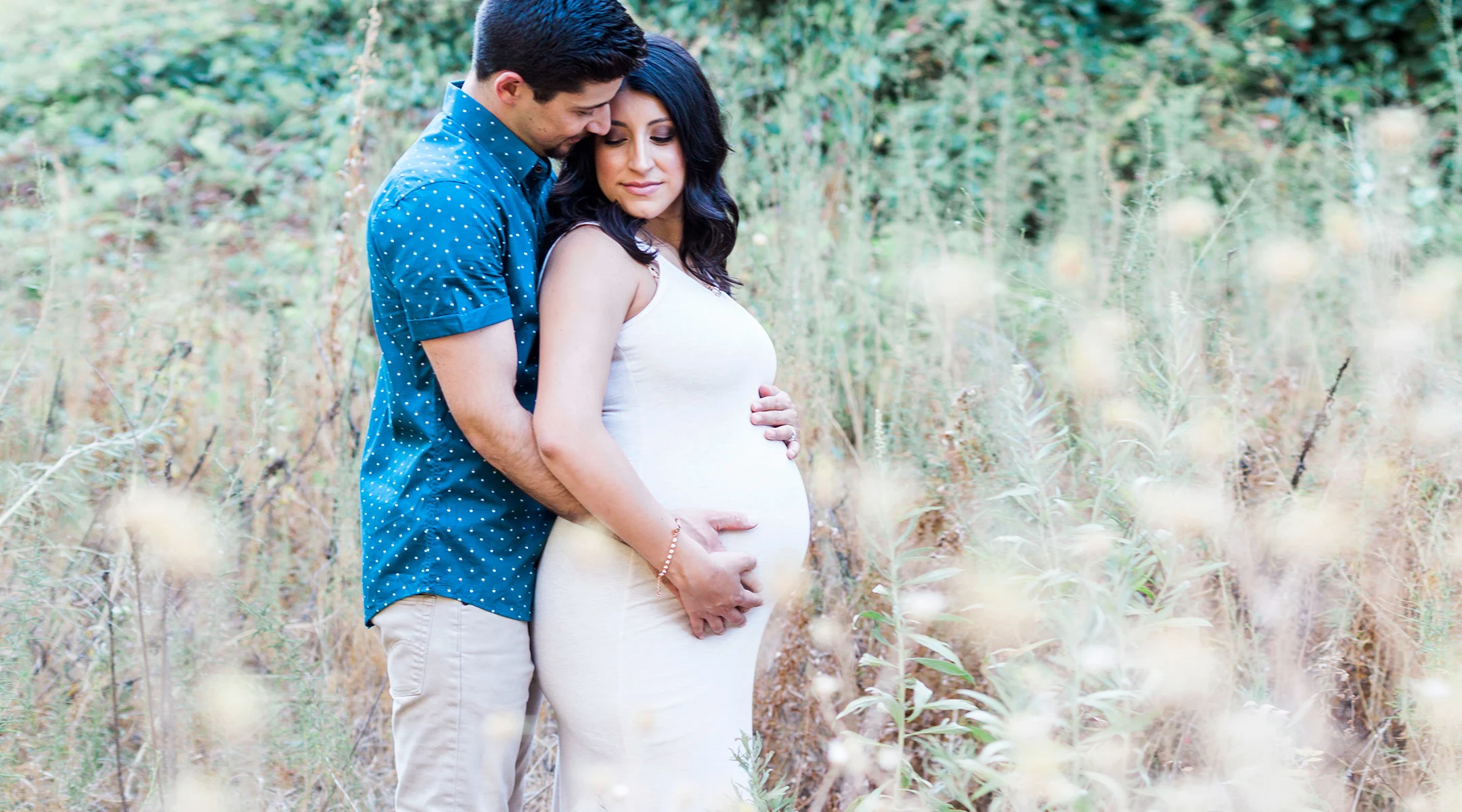 affectionate pregnant couple outside