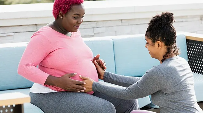 doula helping pregnant person