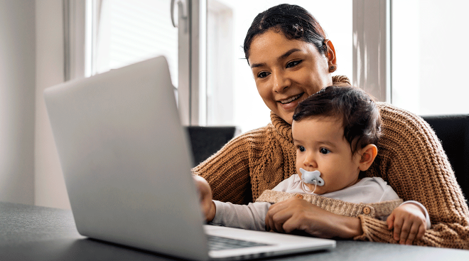 mom and baby looking at laptop at home