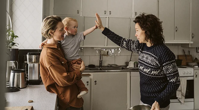 two women parenting a baby at home