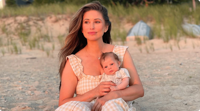 nia sanchez on the beach with baby