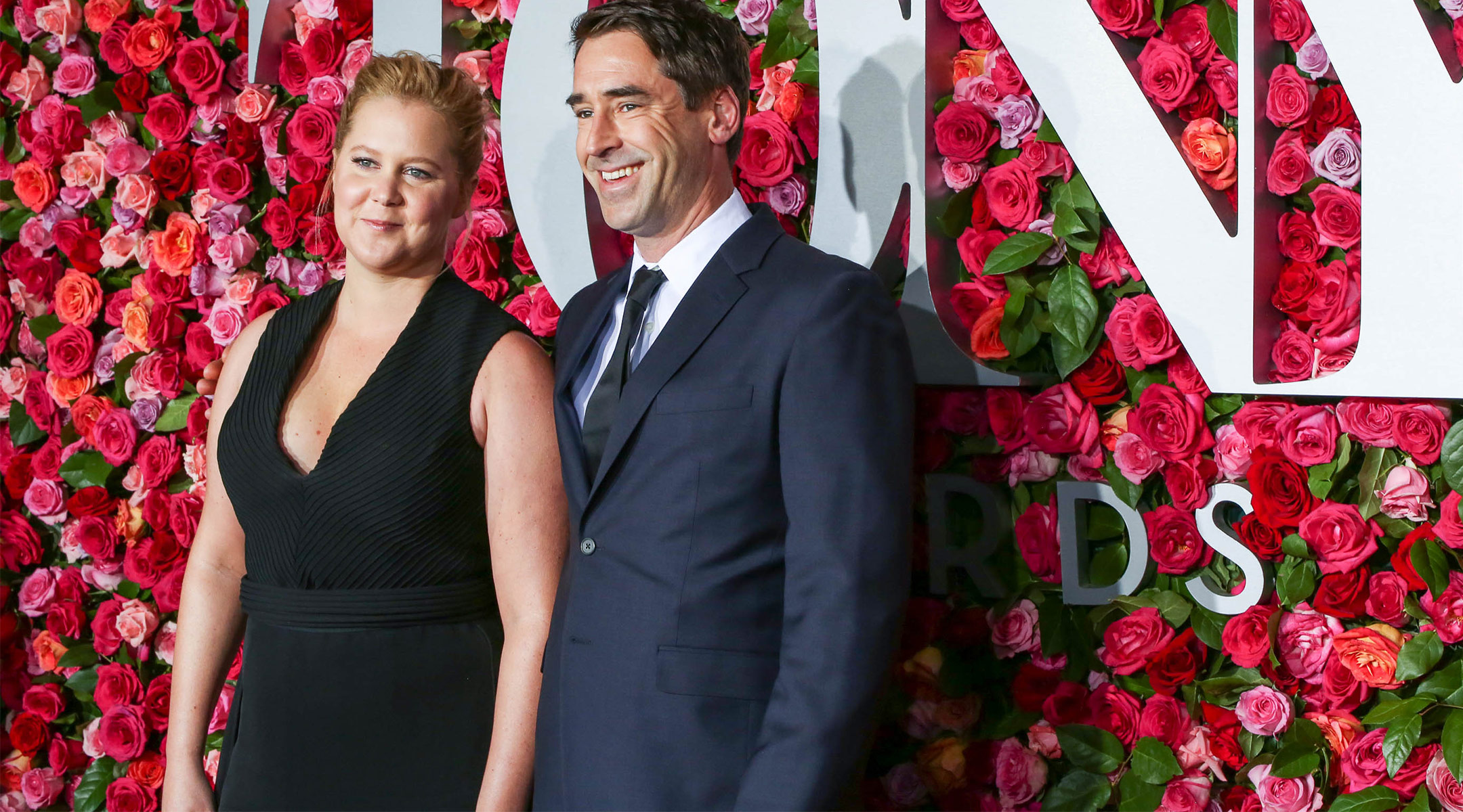 amy schumer announces she's pregnant, pictured with her husband chris fischer