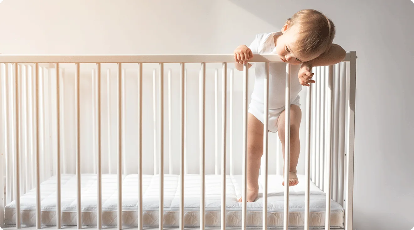 toddler standing in crib