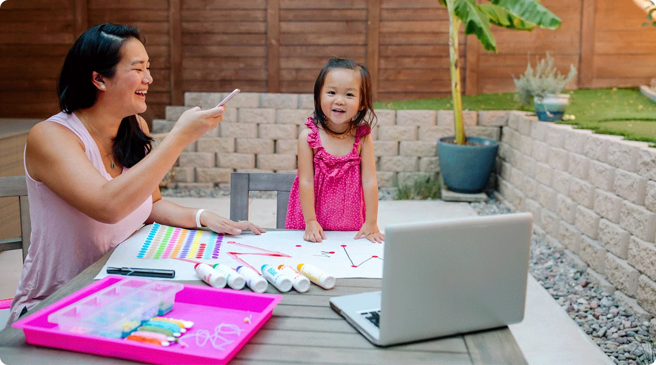 mom and toddler doing arts and crafts outside