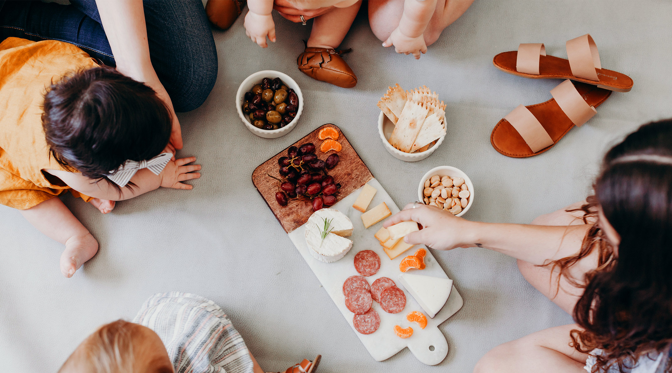 group of moms and babies celebrating small moments with mini picnic