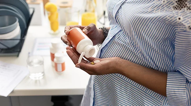 pregnant woman taking a vitamin