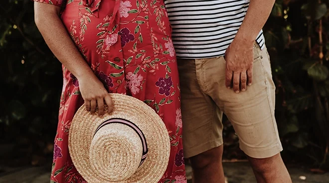 close up of man and pregnant woman on vacation for babymoon