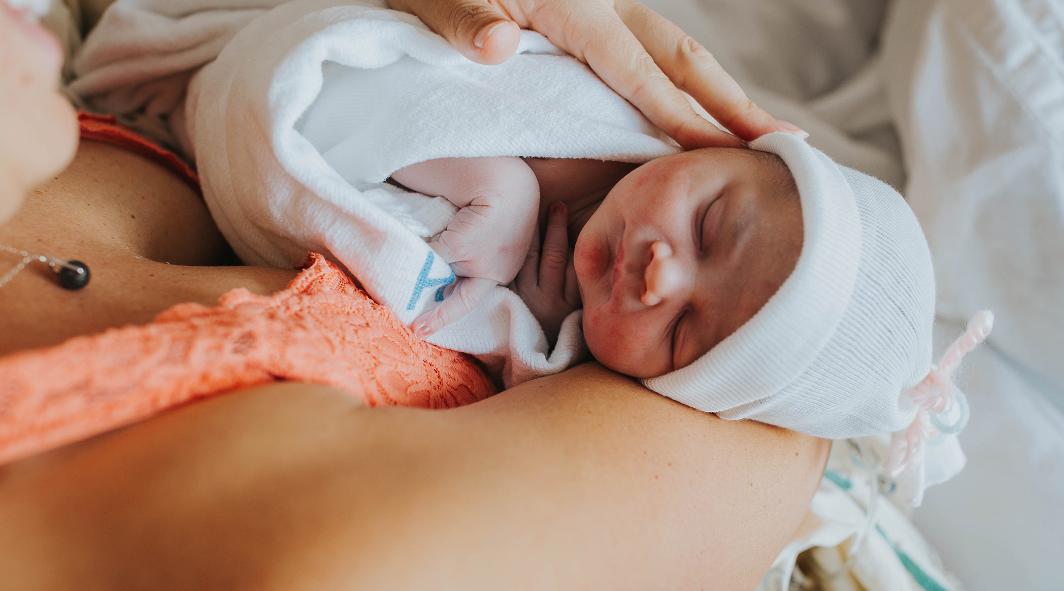 mom holding her new baby just after giving birth