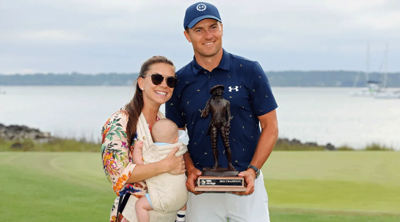 Jordan Spieth poses with the trophy with wife Annie Verret and son Sammy Spieth after winning the RBC Heritage in a playoff at Harbor Town Golf Links on April 17, 2022 in Hilton Head Island, South Carolina