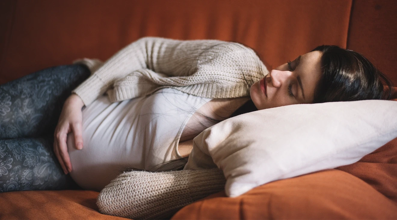 pregnant woman taking a nap on the couch at home