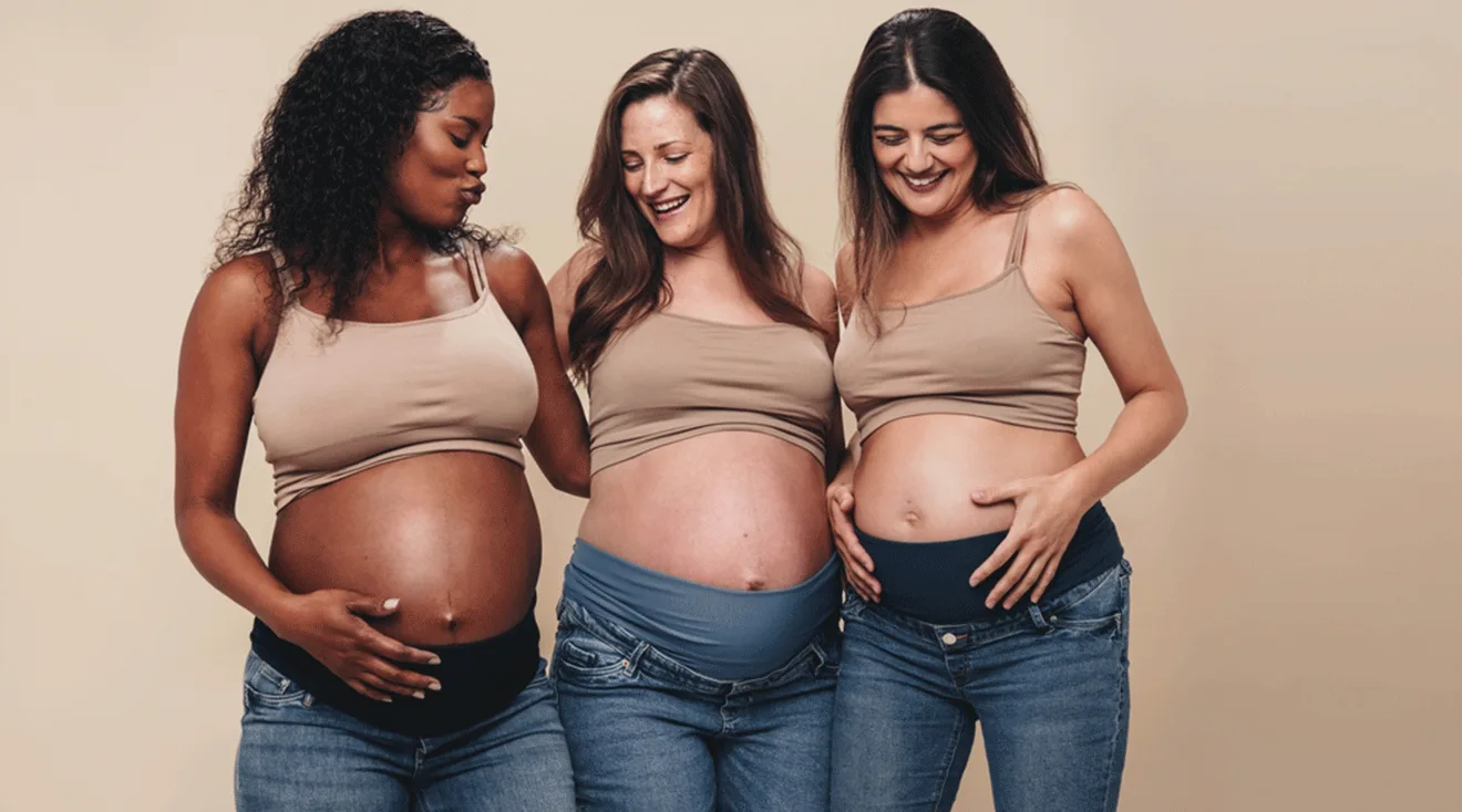 three pregnant women wearing maternity jeans