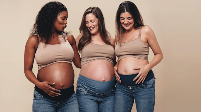 three pregnant women wearing maternity jeans