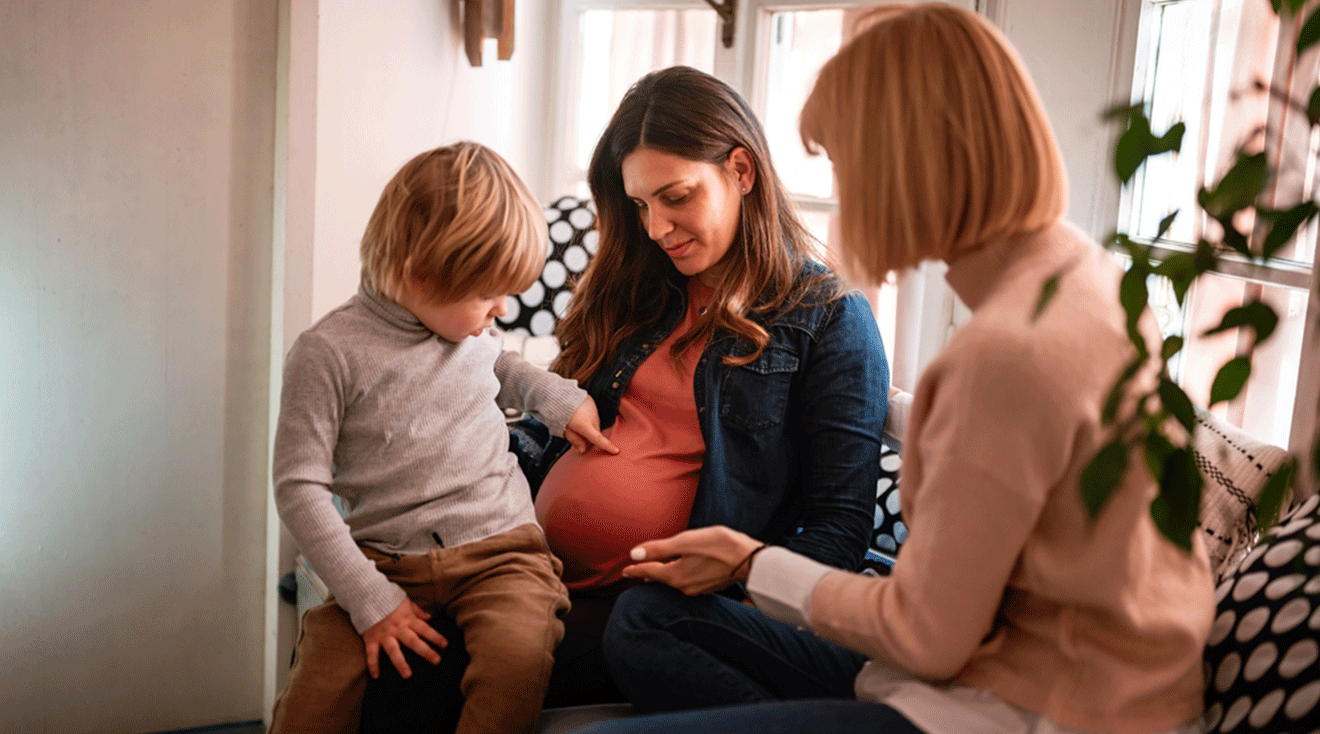 pregnant woman talking to friend