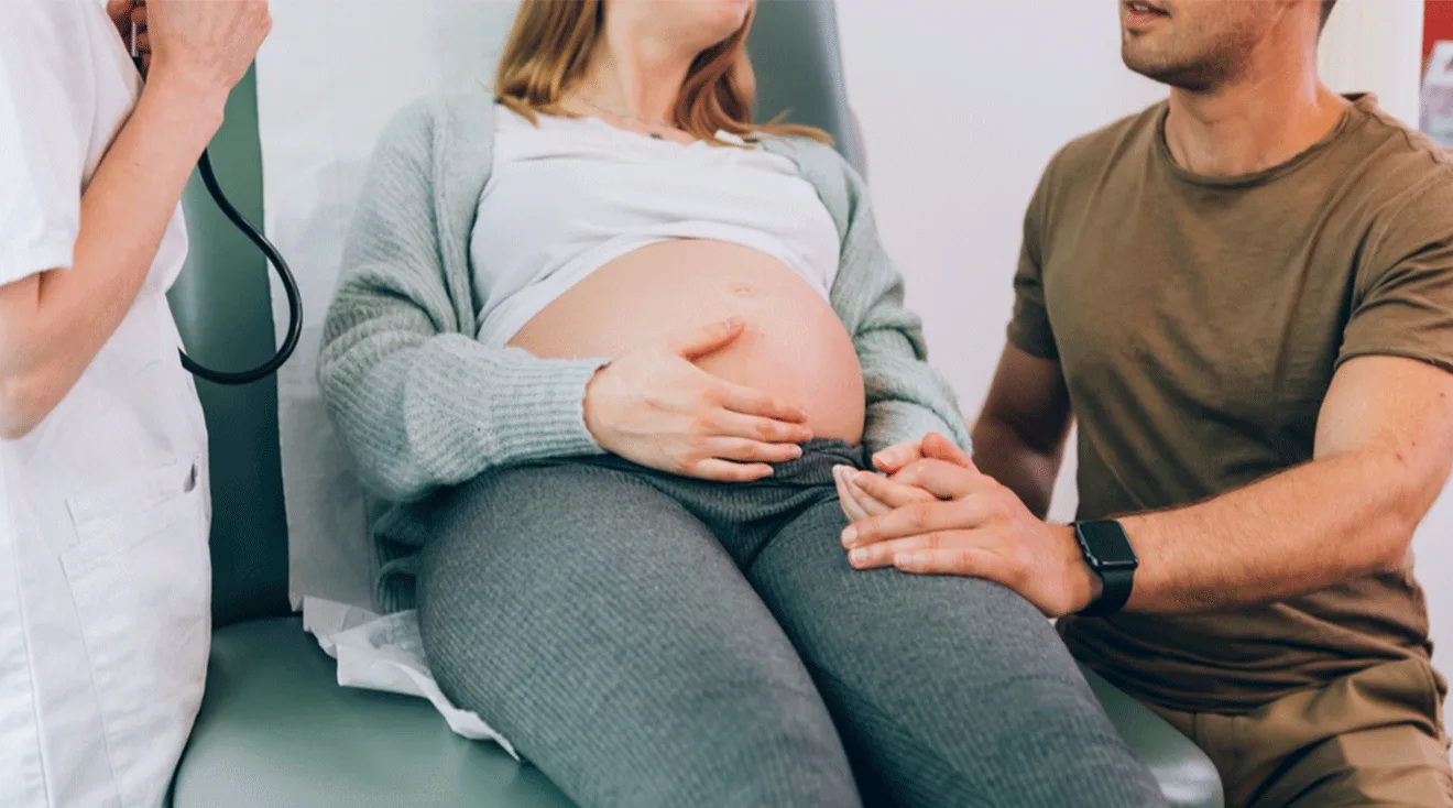 doctor talking to pregnant couple