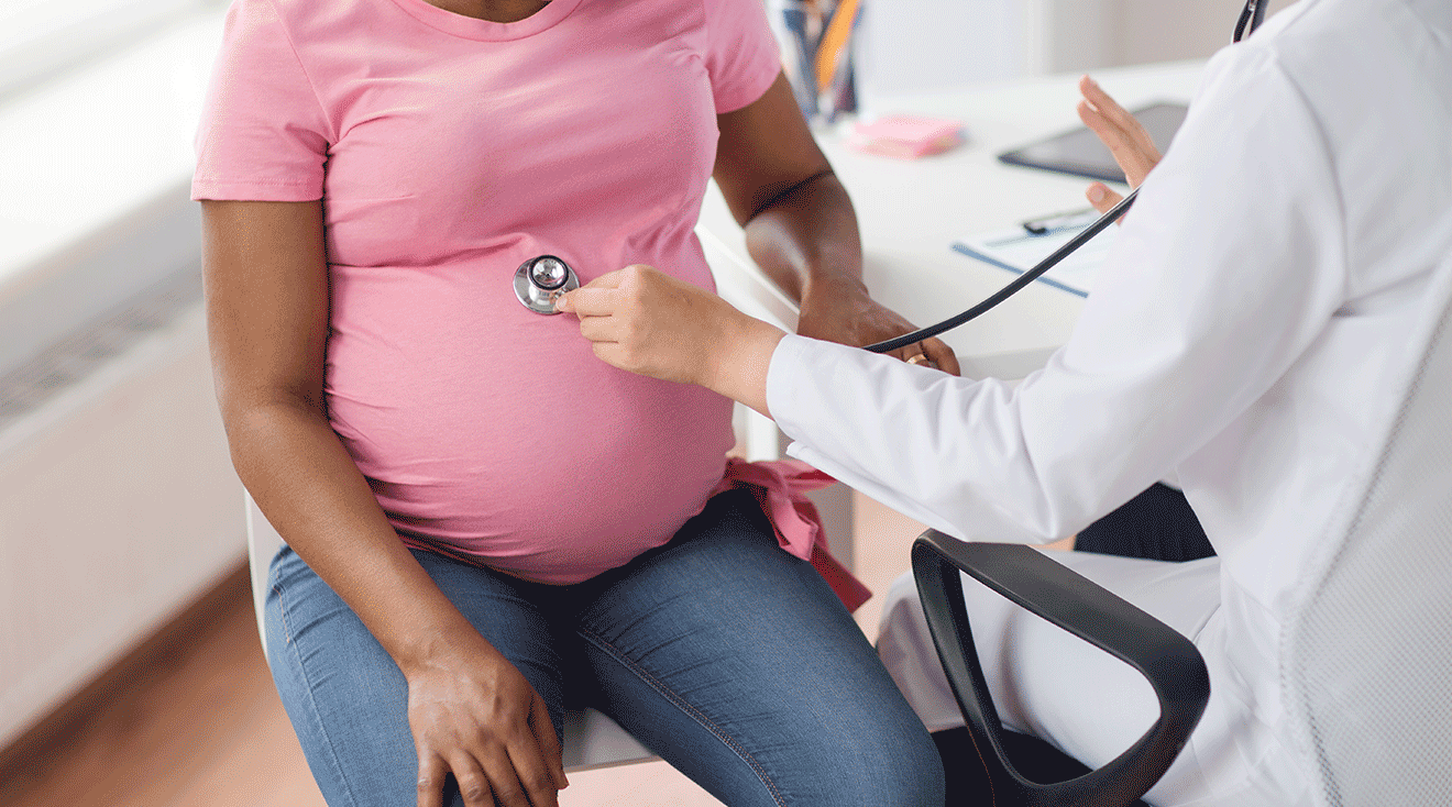 pregnant woman being checked by doctor