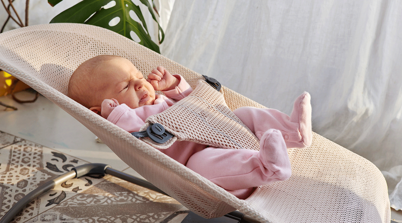 newborn baby sneezing while in baby bouncer