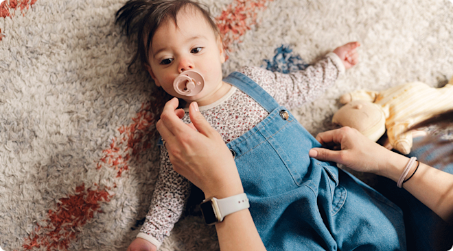 mom taking pacifier out of baby's mouth