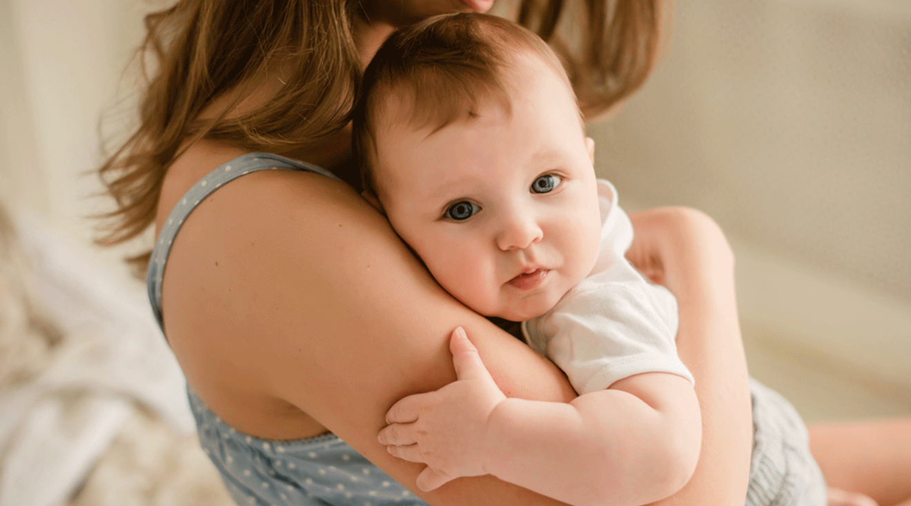 clingy baby holding onto mom