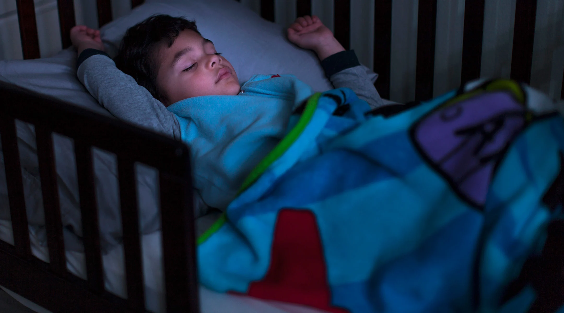 toddler boy sleeping in toddler bed at night