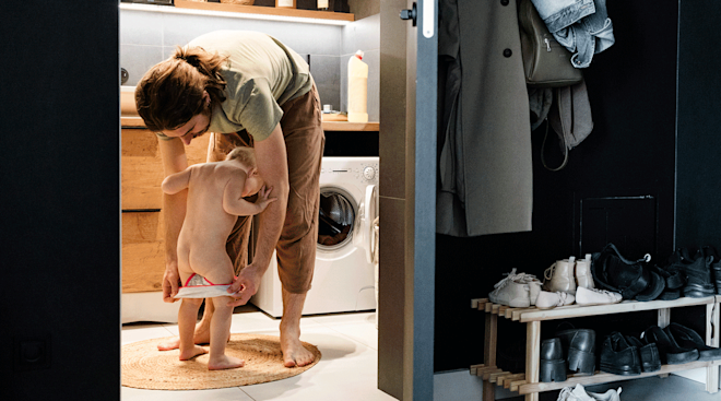 father dressing toddler in new underwear, potty training regression