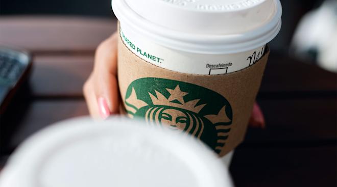hand holding starbucks coffee cup