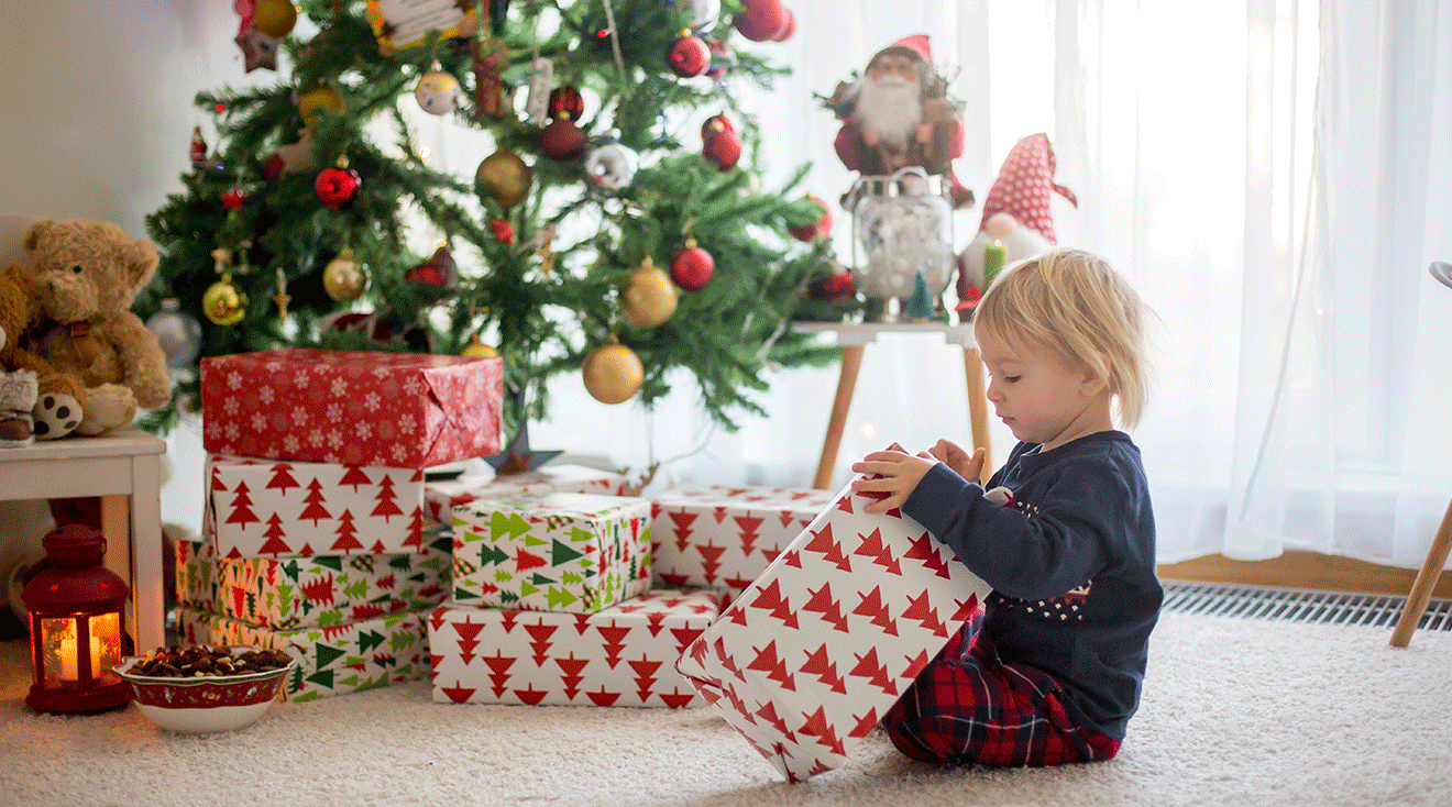 toddler opening christmas gifts on christmas morning