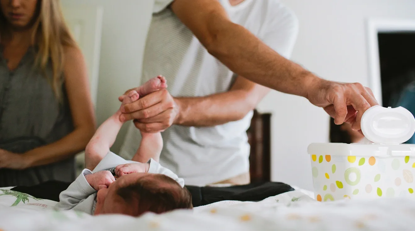 Couple changing baby's diaper