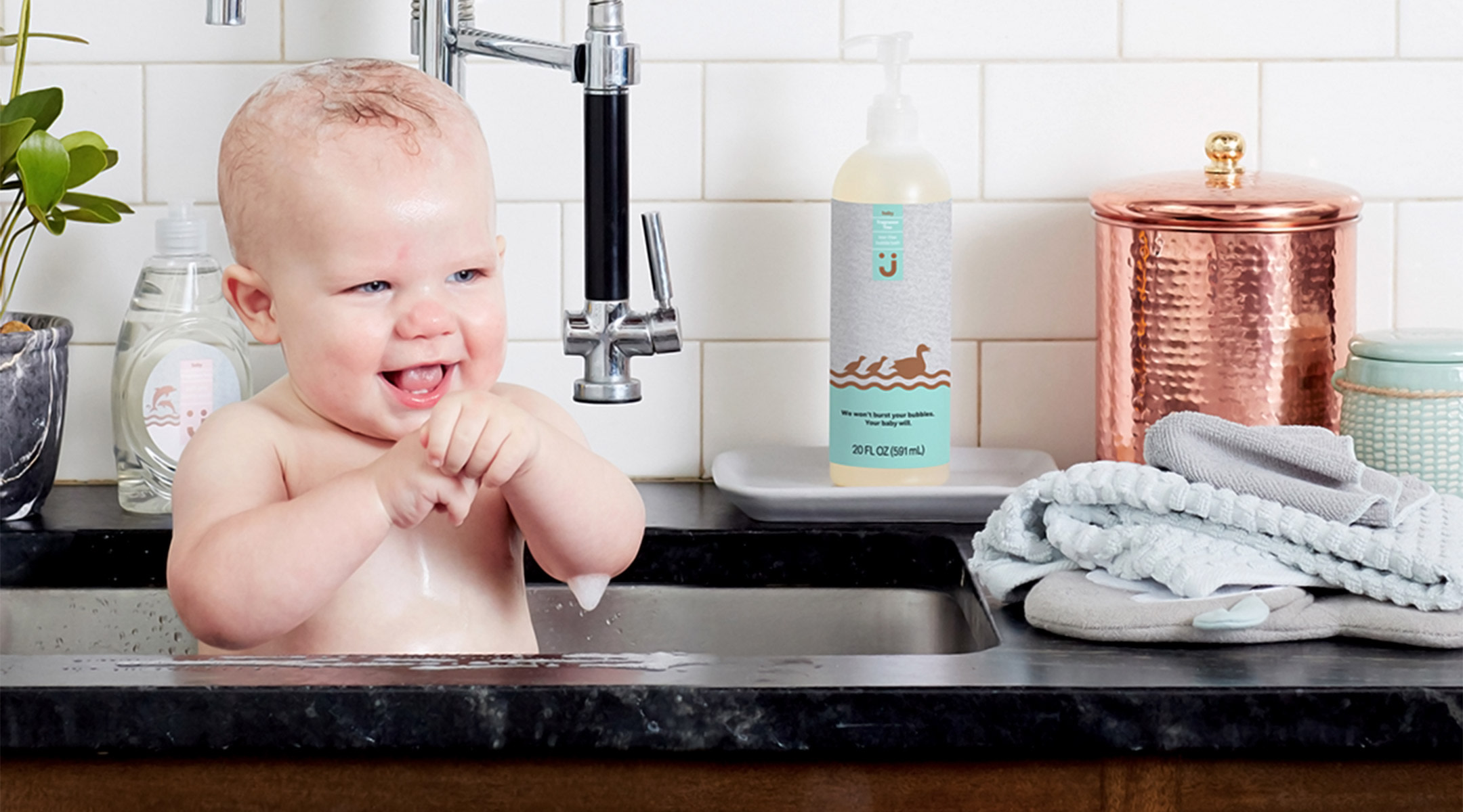 jet launches baby care line, baby taking a bath in the sink