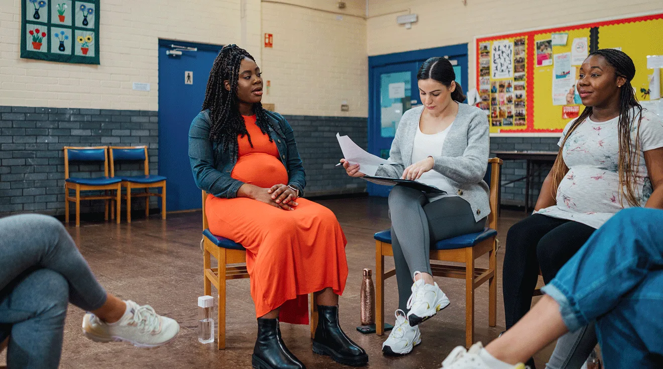 group of pregnant women talking in a circle