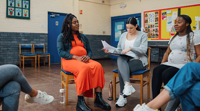 group of pregnant women talking in a circle