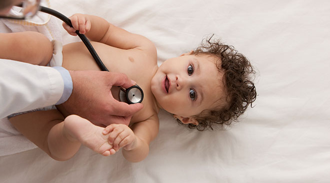 doctor listening to baby's heartbeat 