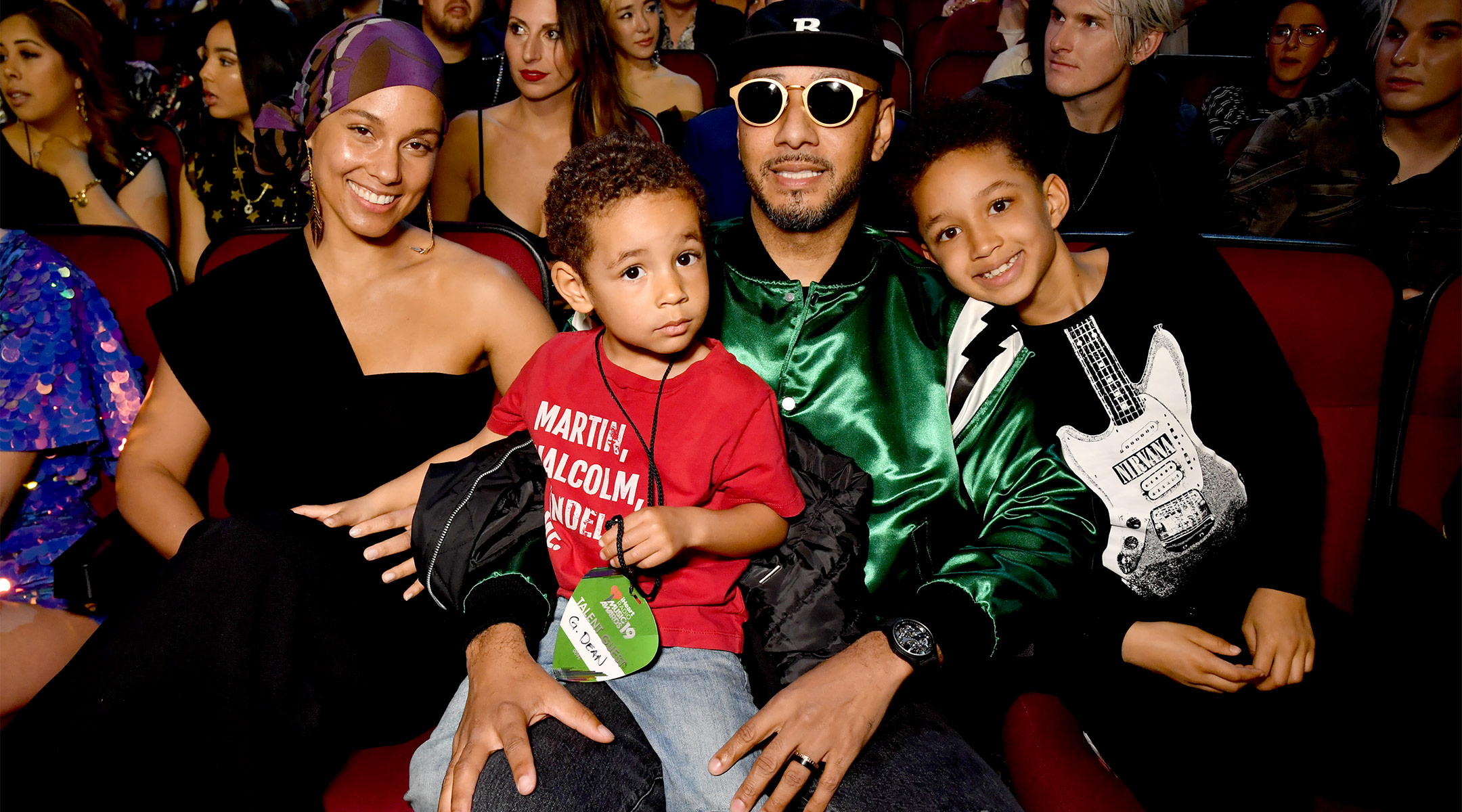 alicia keys sitting with her family at an event