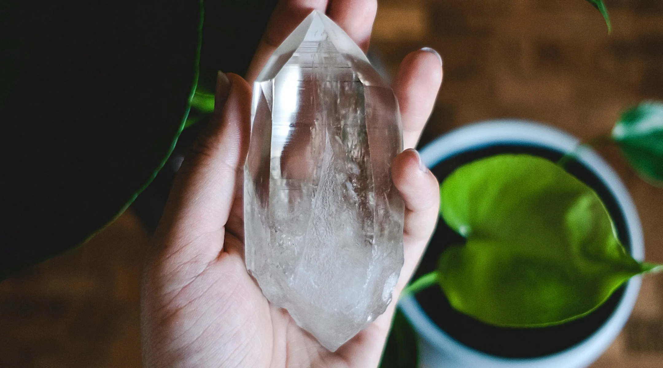 woman's hand holding healing crystal