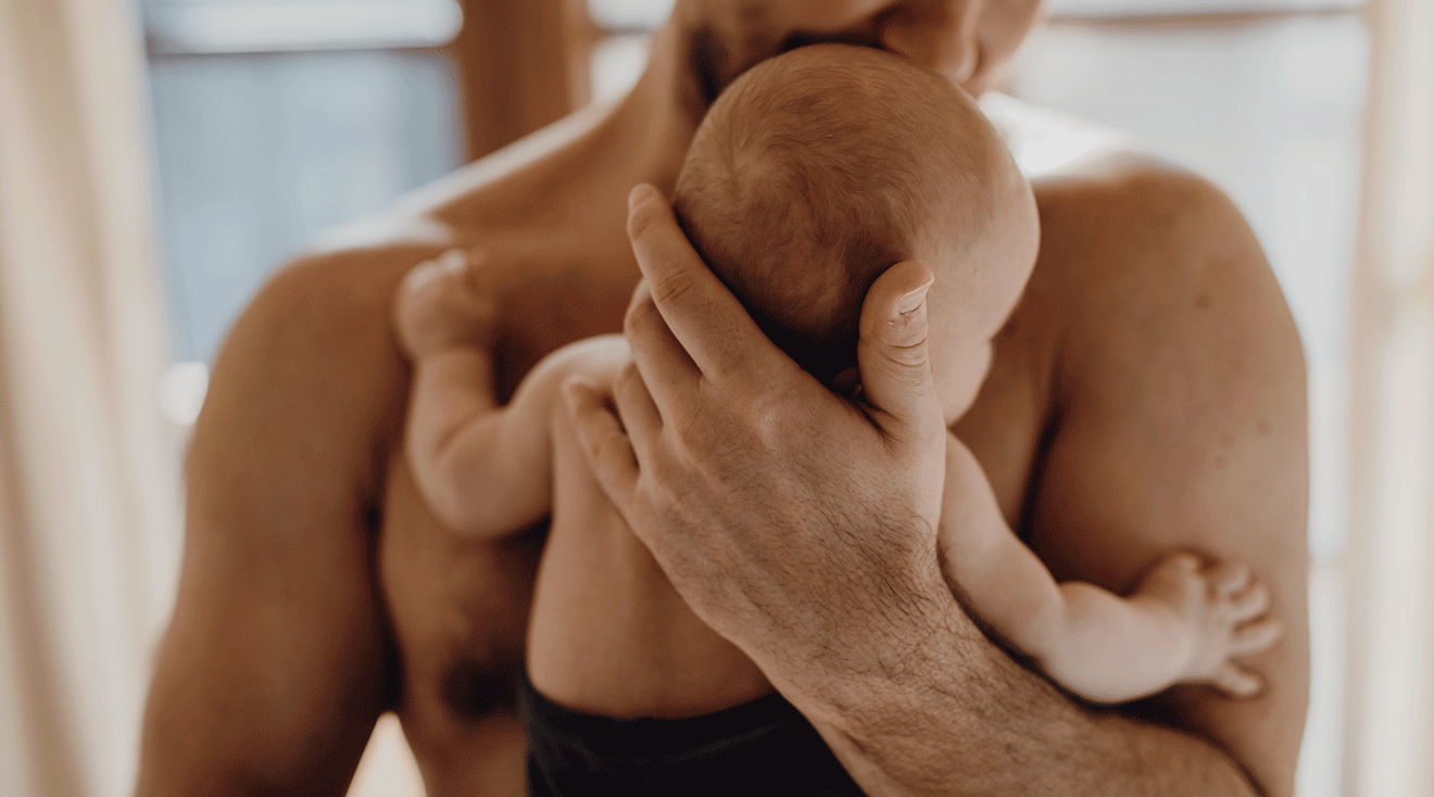 parent holding baby close to chest, skin to skin