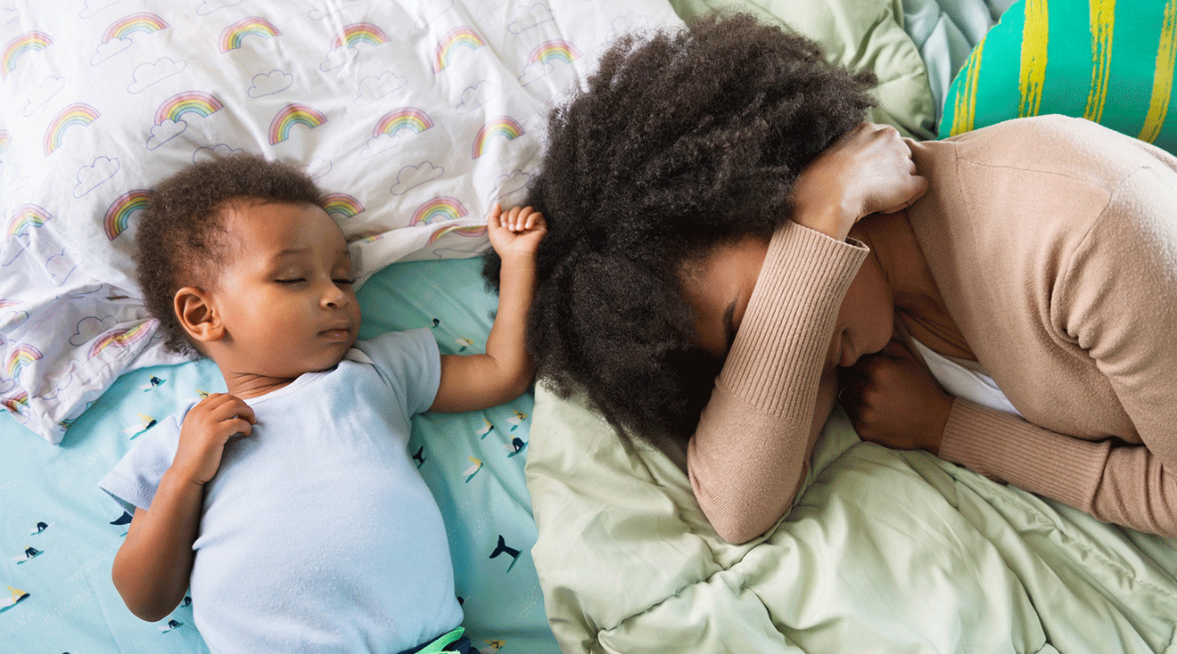 exhausted mother sleeping next to young son