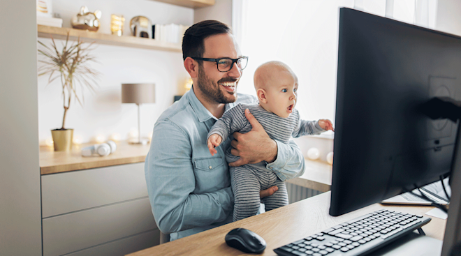 dad sitting at desk with baby