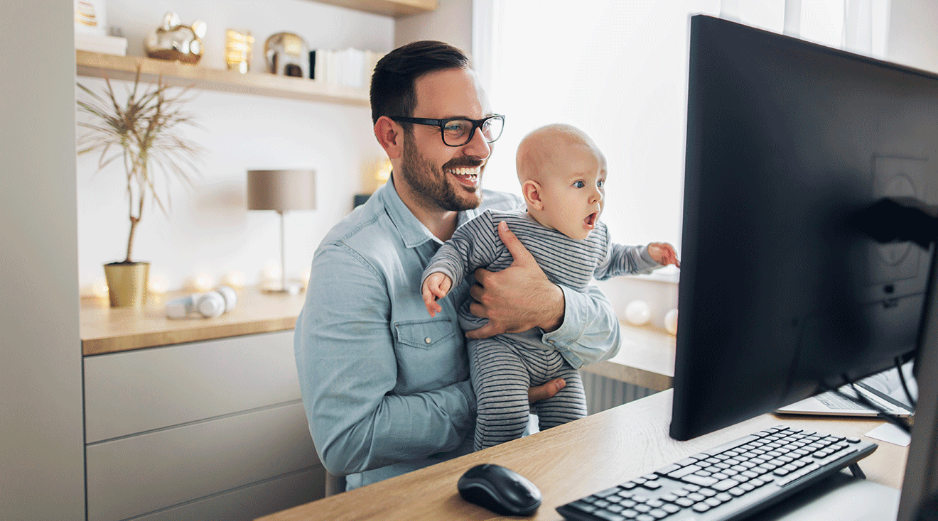 dad sitting at desk with baby